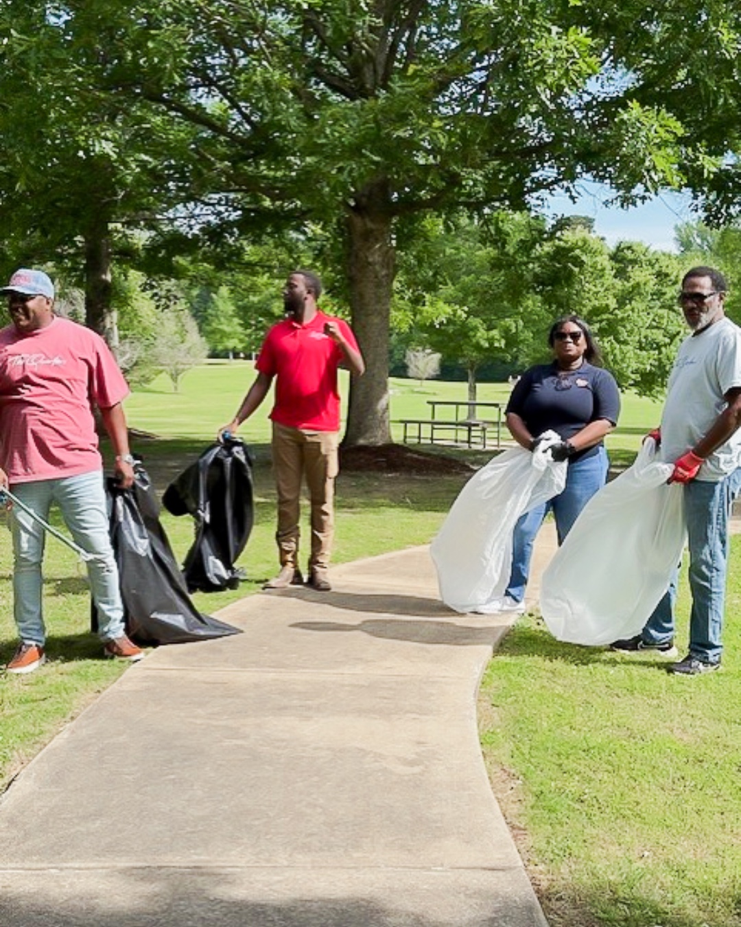 Tailwind Group employees volunteering and cleaning up an area park