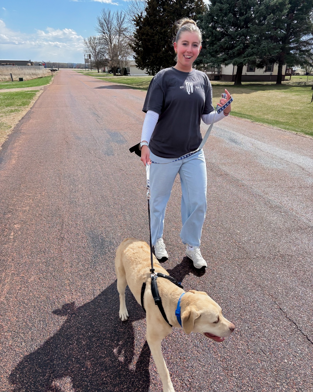 Tailwind Group employee doing volunteer work in the community by walking a dog