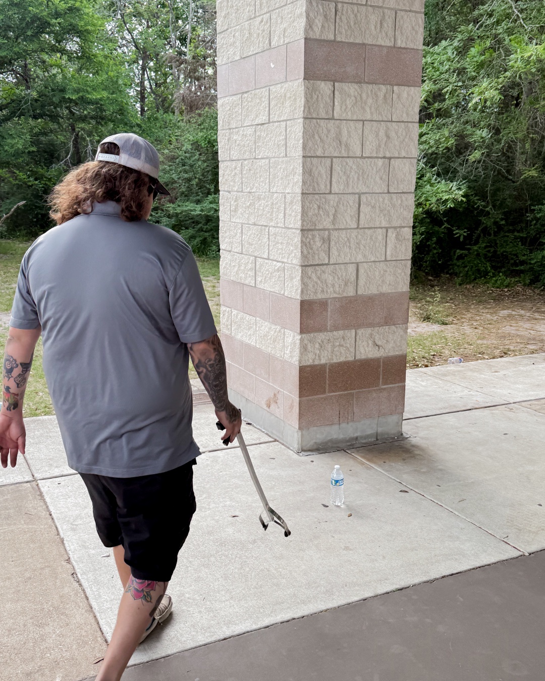 Tailwind employee volunteering by cleaning up garbage in a local park